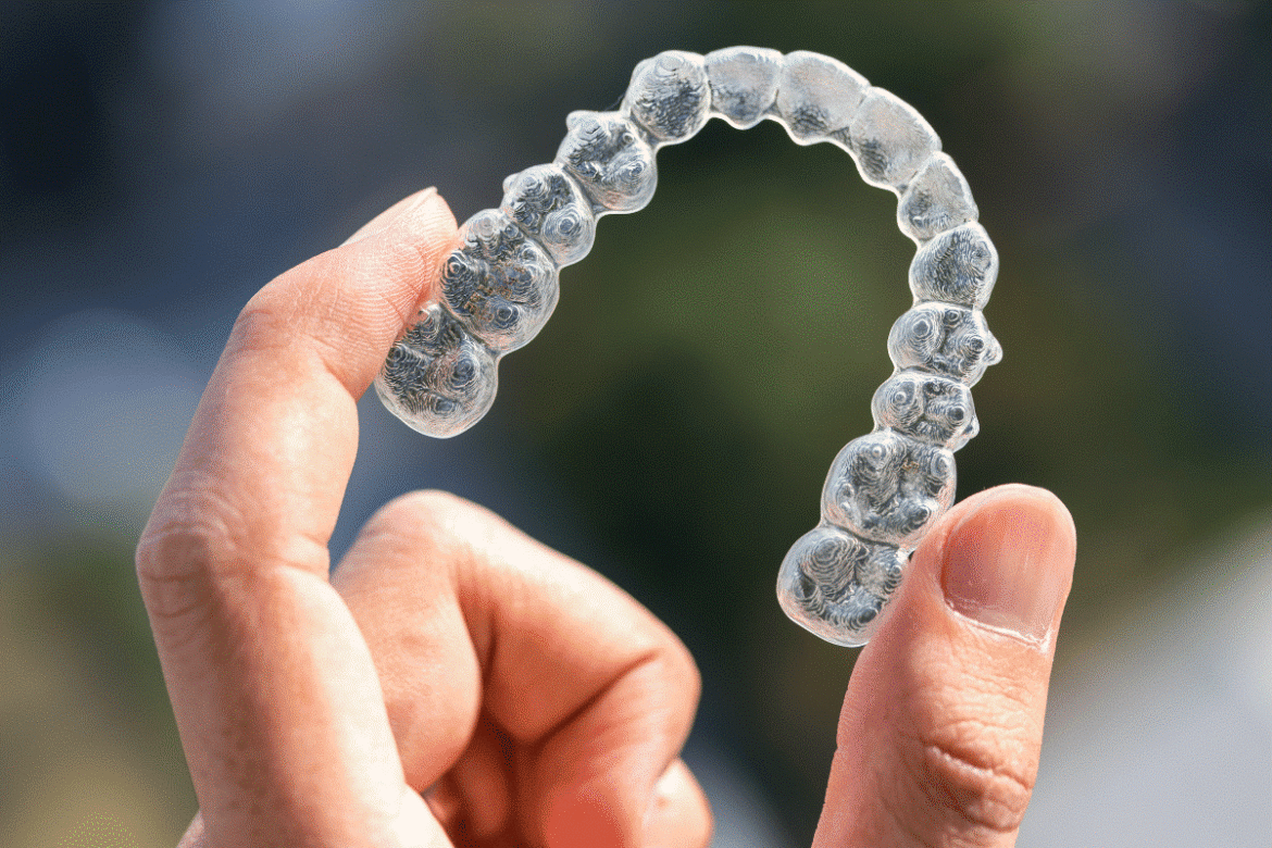 Orthodontist-in-Al-Ain-checking-teeth-alignment-and-retainer-fit-after-braces-removal-2.png